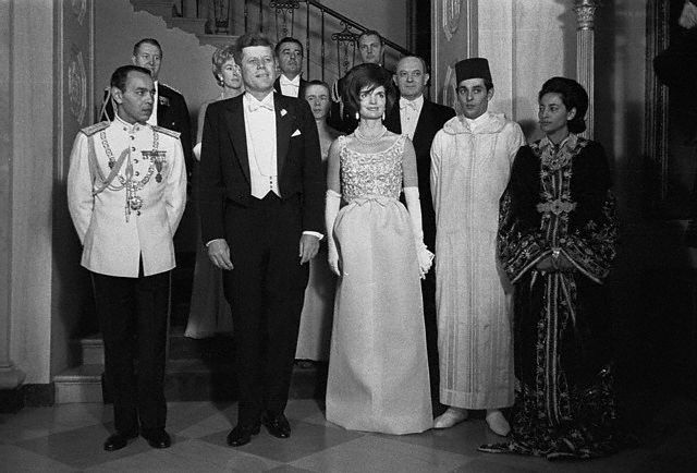 27 Mar 1963, Washington, DC, USA --- President and Mrs. Kennedy were hosts tonight at State dinner in honor of King Hassan II of Morocco at the White House.  Shown prior to the dinner, front row, are left to right: King Hassan II; The Chief Executive; The First Lady; Prince Noulay Abdallah, the King's brother; and Princess Lalla Nesha, the king's sister.  Back row; Maj. Gen. Chester V. Clifton, USA; Mrs. Angier Biddle Duke, wife of the Chief of Protocol; Brig. Gen. Godfrey T. McHugh, USAF; Mrs. Dean Rusk; Captain Tazewell Shepard, USN; and Secretary of State Dean Rusk. --- Image by © Bettmann/CORBIS